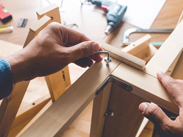 Handyman assembling Ikea furniture