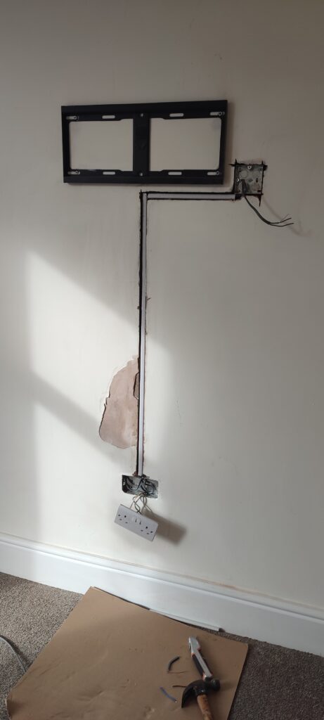 Wall chase with hidden cables behind TV mount