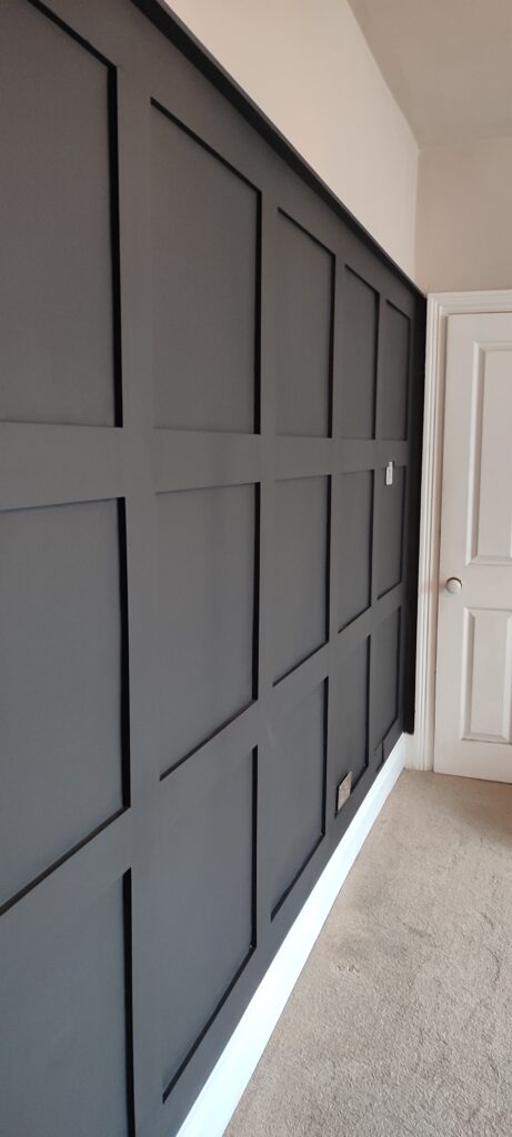 Shaker style full wall panelling painted with Farrow & Ball Railings colour