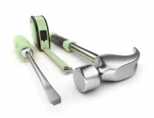A hammer, screwdriver and tape measure on a white surface